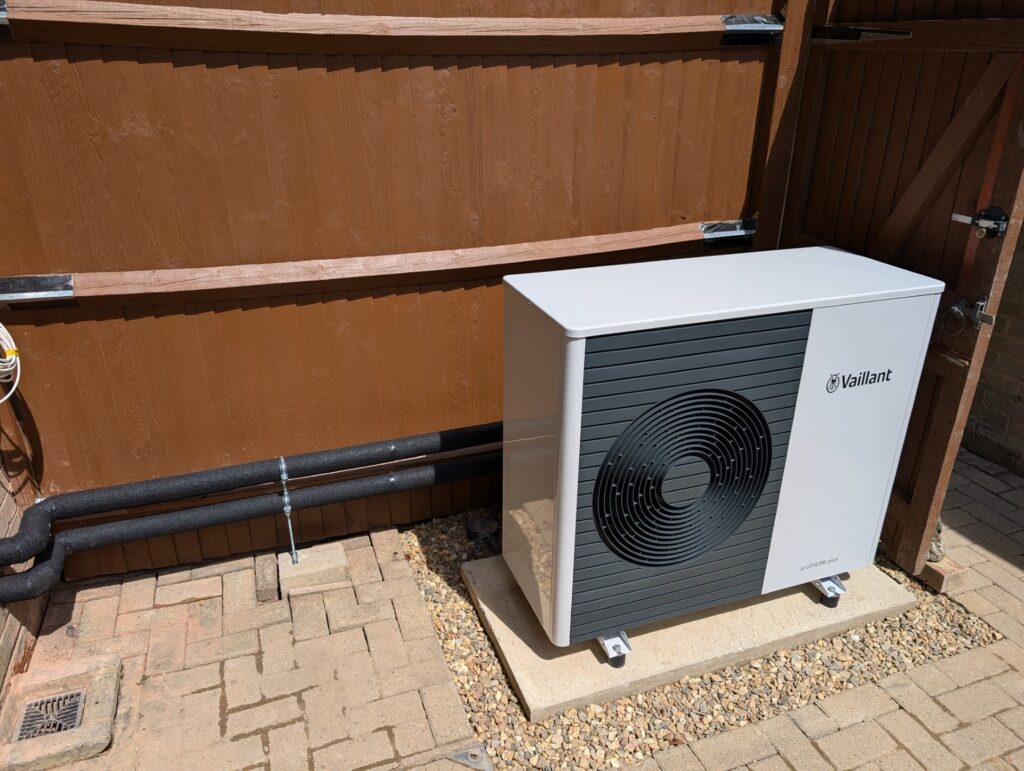 Single-fan Vaillant outdoor heat pump unit installed on concrete base